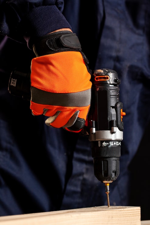 Hardware template hero — cordless drill with safety glove